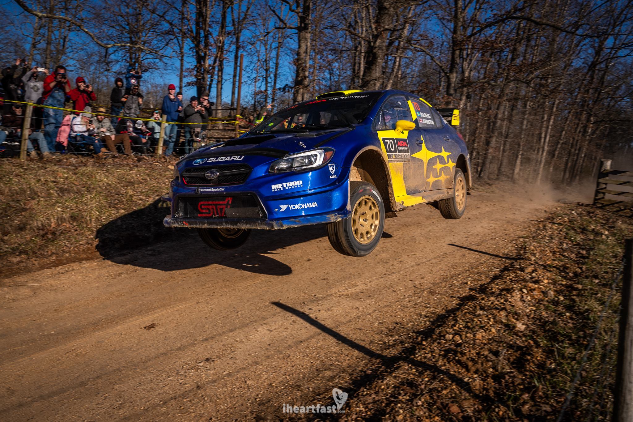 Oliver Solberg flying over the famous cattle guard jump in his Subaru Motorsports STI at 100 Acre Wood