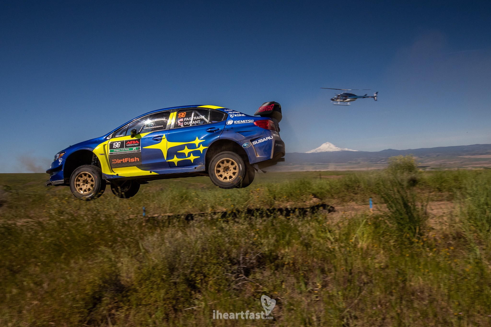 Pastrana flies over the mountain as a helicopter follows